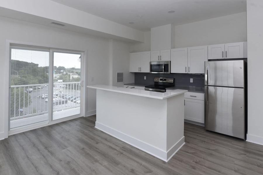 Apartment kitchen with balcony door and water view
