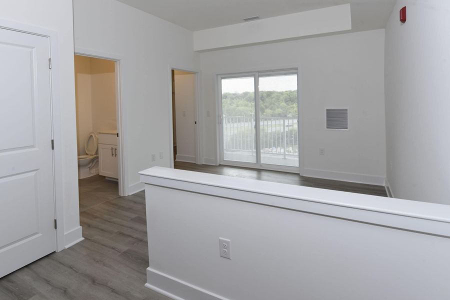 Living area with balcony door overlooking the water