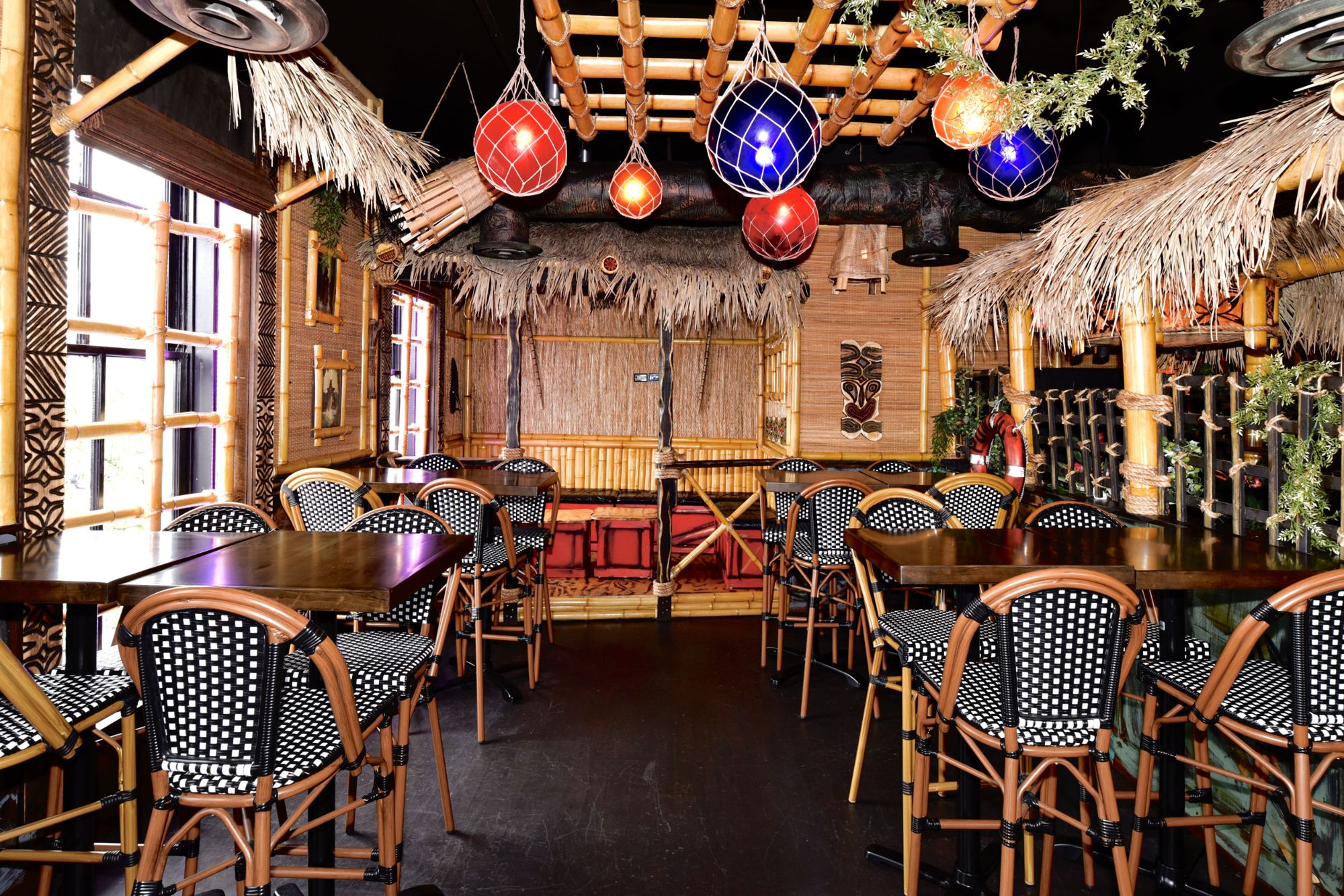 Ponche Tiki Bar with thatched ceiling and glass float lanterns