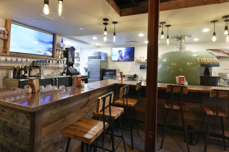 Timber Pizza bar seating and pizza oven